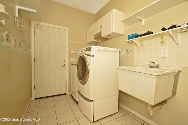 401 Stonehenge Cir, Rockledge, FL 32955 - washroom with washer / dryer, light tile patterned flooring, and cabinet space