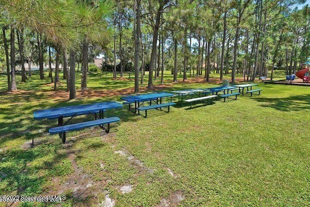 401 Stonehenge Cir, Rockledge, FL 32955 - surrounding community featuring a lawn