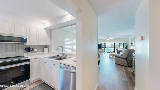 3799 S Banana River Blvd Unit 1025, Cocoa Beach, FL 32931 - kitchen with appliances with stainless steel finishes, light wood-style flooring, and white cabinetry