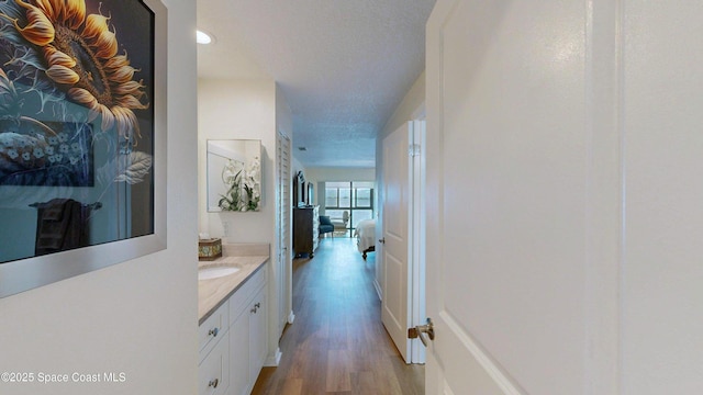 3799 S Banana River Blvd Unit 1025, Cocoa Beach, FL 32931 - hall featuring light wood-style floors, recessed lighting, and a textured ceiling
