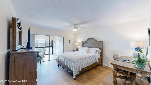 3799 S Banana River Blvd Unit 1025, Cocoa Beach, FL 32931 - bedroom with light wood finished floors, a textured ceiling, a closet, and a ceiling fan