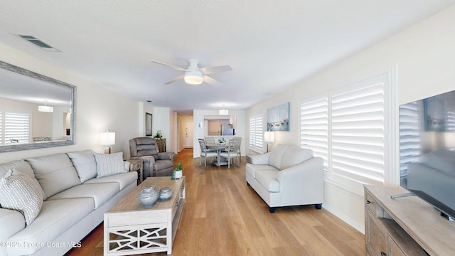 3799 S Banana River Blvd Unit 1025, Cocoa Beach, FL 32931 - living area featuring healthy amount of natural light, light wood finished floors, and a ceiling fan
