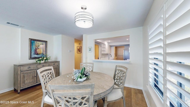 3799 S Banana River Blvd Unit 1025, Cocoa Beach, FL 32931 - dining room with wood finished floors and baseboards