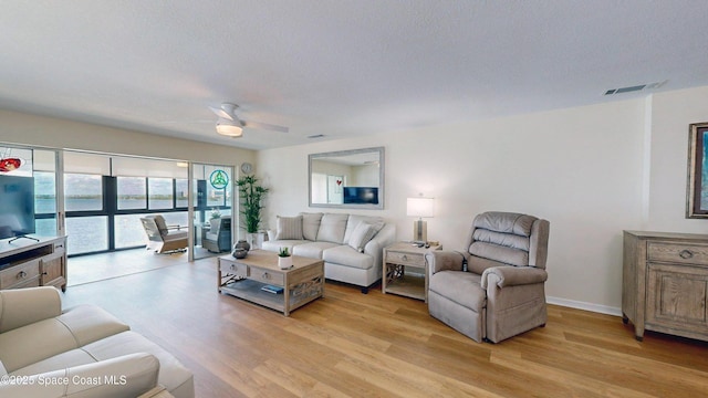 3799 S Banana River Blvd Unit 1025, Cocoa Beach, FL 32931 - living area with light wood-type flooring, a ceiling fan, and a textured ceiling