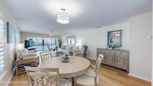 3799 S Banana River Blvd Unit 1025, Cocoa Beach, FL 32931 - dining area with light wood finished floors and a ceiling fan