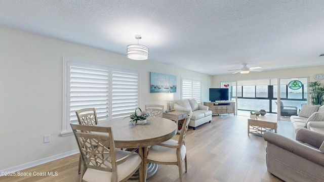 3799 S Banana River Blvd Unit 1025, Cocoa Beach, FL 32931 - dining space featuring a ceiling fan, light wood-style flooring, and a textured ceiling