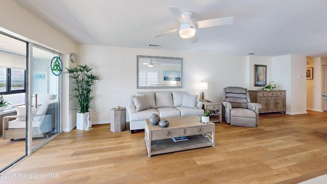3799 S Banana River Blvd Unit 1025, Cocoa Beach, FL 32931 - living room with healthy amount of natural light, light wood finished floors, and a ceiling fan