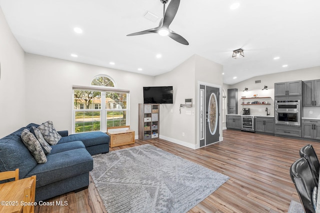 1218 Rolling Meadows Dr, Rockledge, FL 32955 - living area with wine cooler, recessed lighting, wood finished floors, ceiling fan, and vaulted ceiling