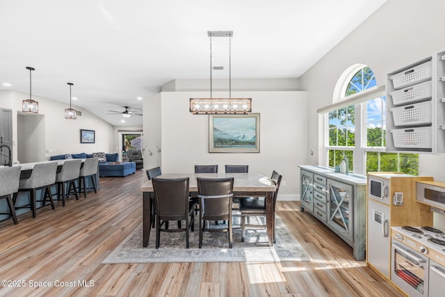 1218 Rolling Meadows Dr, Rockledge, FL 32955 - dining space featuring light wood-style floors, ceiling fan, and vaulted ceiling
