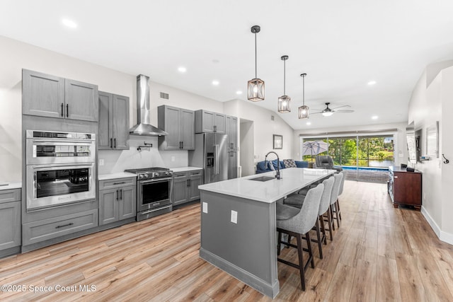 1218 Rolling Meadows Dr, Rockledge, FL 32955 - kitchen featuring high quality appliances, gray cabinetry, wall chimney exhaust hood, a ceiling fan, and light countertops
