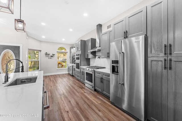 1218 Rolling Meadows Dr, Rockledge, FL 32955 - kitchen with high quality appliances, wood finished floors, recessed lighting, light stone countertops, and gray cabinets