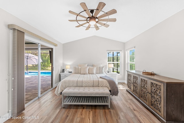 1218 Rolling Meadows Dr, Rockledge, FL 32955 - bedroom featuring access to exterior, vaulted ceiling, light wood-style floors, and multiple windows