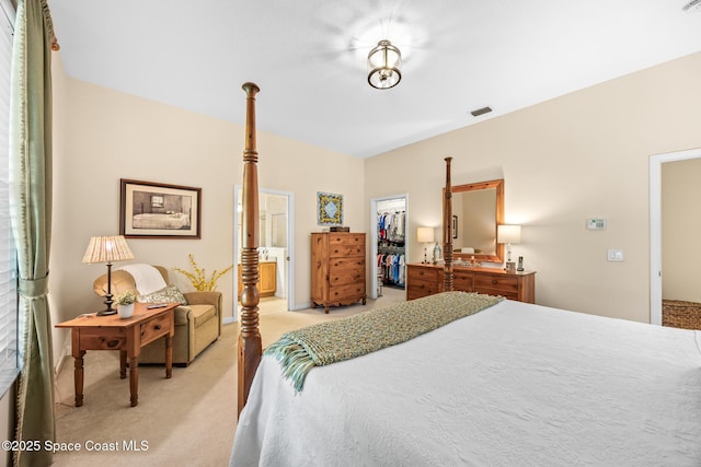 4595 Alan Shepard Ave, Cocoa, FL 32926 - bedroom featuring light carpet, a spacious closet, a closet, and ensuite bathroom