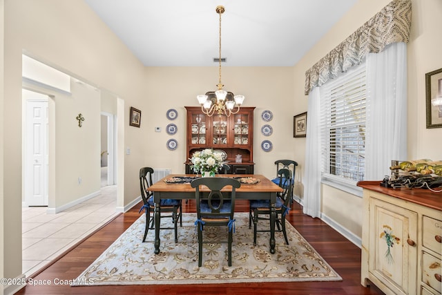 4595 Alan Shepard Ave, Cocoa, FL 32926 - dining space featuring a chandelier and dark wood-style floors
