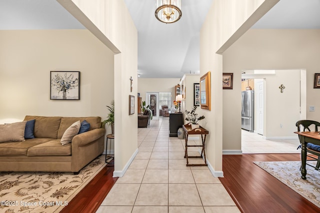 4595 Alan Shepard Ave, Cocoa, FL 32926 - foyer featuring a high ceiling, light wood finished floors, and a chandelier
