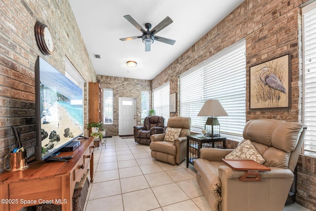 4595 Alan Shepard Ave, Cocoa, FL 32926 - living area featuring light tile patterned flooring, ceiling fan, and brick wall