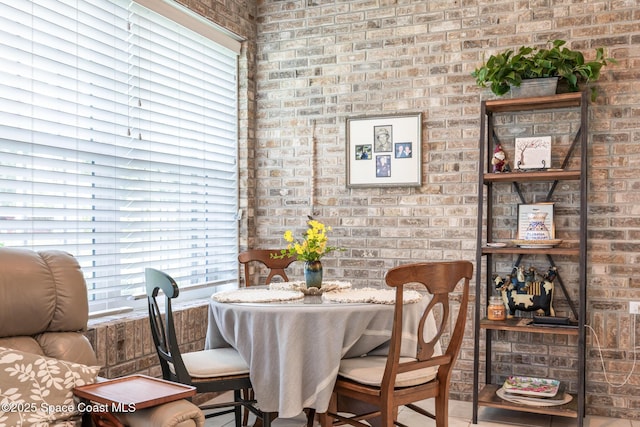 4595 Alan Shepard Ave, Cocoa, FL 32926 - dining area featuring brick wall