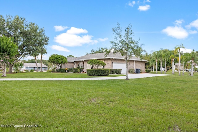 4595 Alan Shepard Ave, Cocoa, FL 32926 - ranch-style house featuring a front lawn, an attached garage, concrete driveway, and brick siding