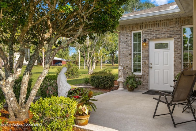 4595 Alan Shepard Ave, Cocoa, FL 32926 - entrance to property with a patio area, brick siding, and a shingled roof