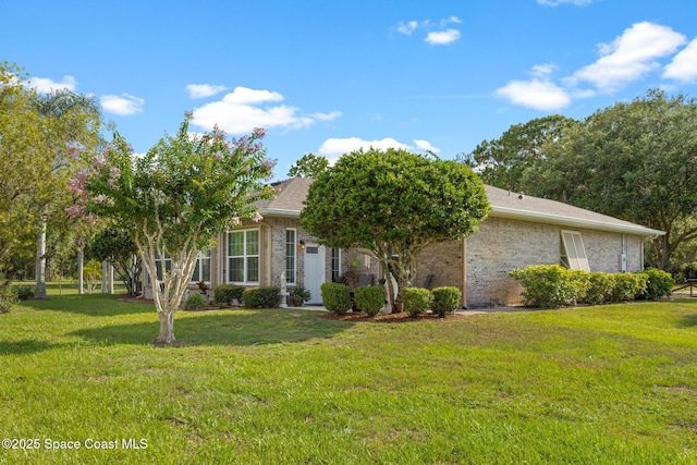 4595 Alan Shepard Ave, Cocoa, FL 32926 - view of property hidden behind natural elements with a front lawn and brick siding