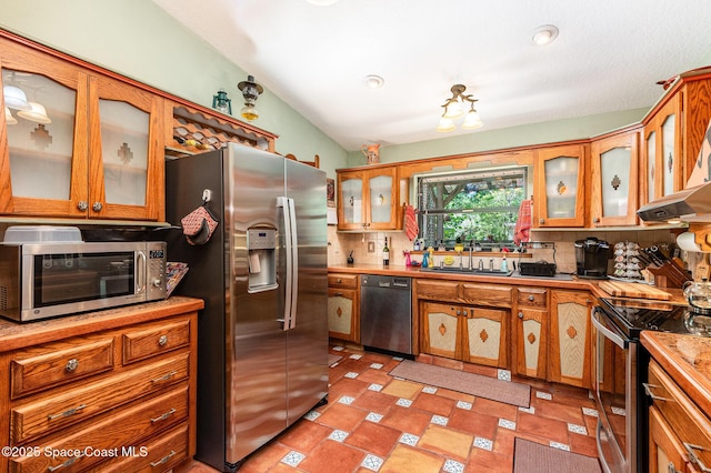 3717 SW Bayfield St, Cocoa, FL 32926 - kitchen with appliances with stainless steel finishes, backsplash, and light countertops