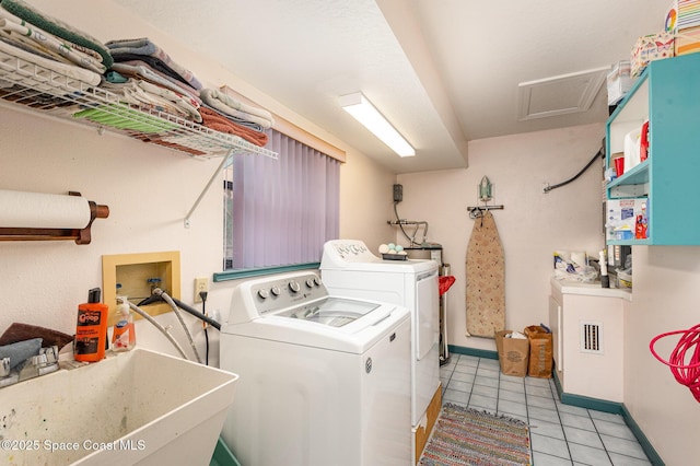 3717 SW Bayfield St, Cocoa, FL 32926 - laundry room with washer and dryer, light tile patterned floors, and attic access