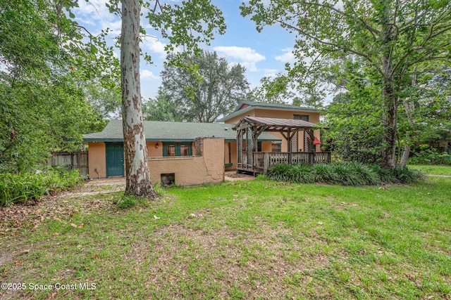 3717 SW Bayfield St, Cocoa, FL 32926 - back of property with a gazebo, stucco siding, and a wooden deck