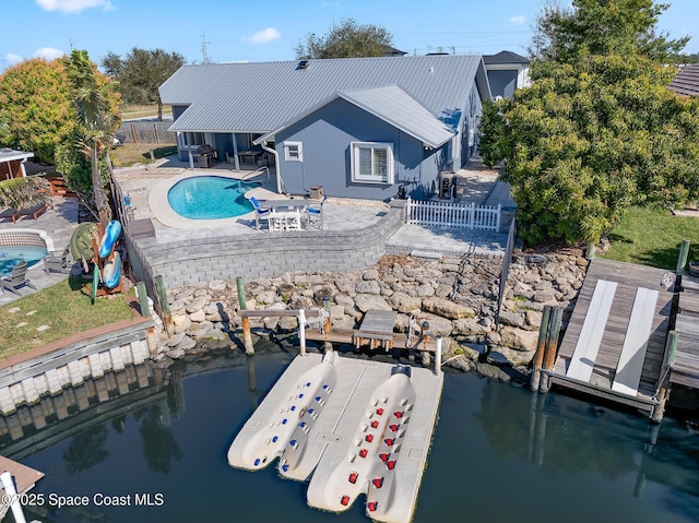 100 Matthews St, Satellite Beach, FL 32937 - back of house featuring a fenced backyard, a patio area, an outdoor pool, and stucco siding
