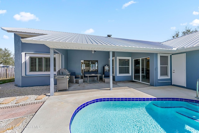 100 Matthews St, Satellite Beach, FL 32937 - back of house featuring stucco siding, a patio, a metal roof, and an outdoor pool