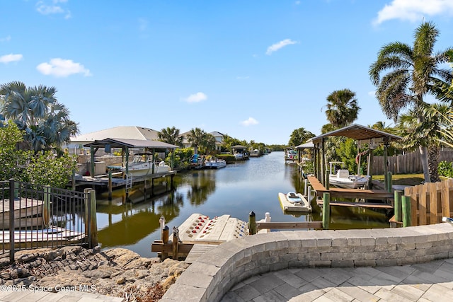 100 Matthews St, Satellite Beach, FL 32937 - dock featuring boat lift and a water view