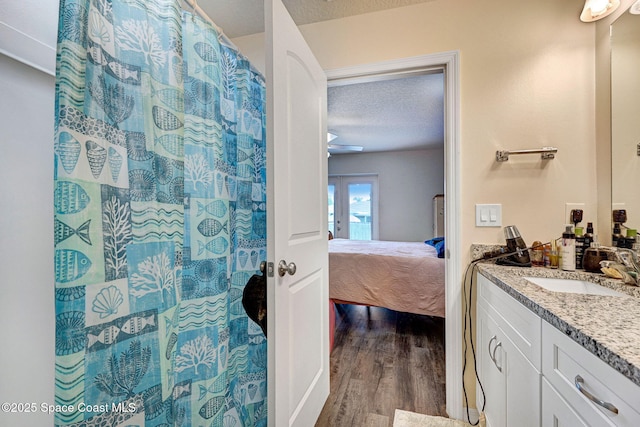 1689 Colorado St SE, Palm Bay, FL 32909 - full bath featuring a textured ceiling, vanity, wood finished floors, and ensuite bath
