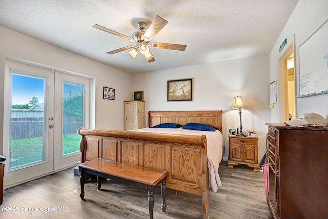 1689 Colorado St SE, Palm Bay, FL 32909 - bedroom with french doors, access to outside, wood finished floors, a textured ceiling, and ceiling fan