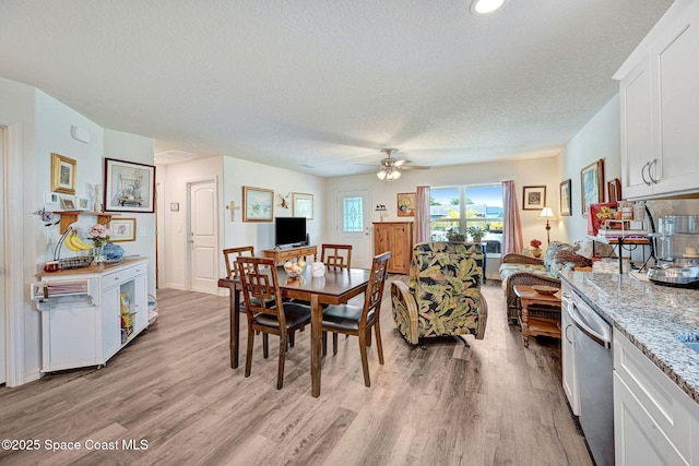 1689 Colorado St SE, Palm Bay, FL 32909 - dining space with light wood finished floors, ceiling fan, and a textured ceiling