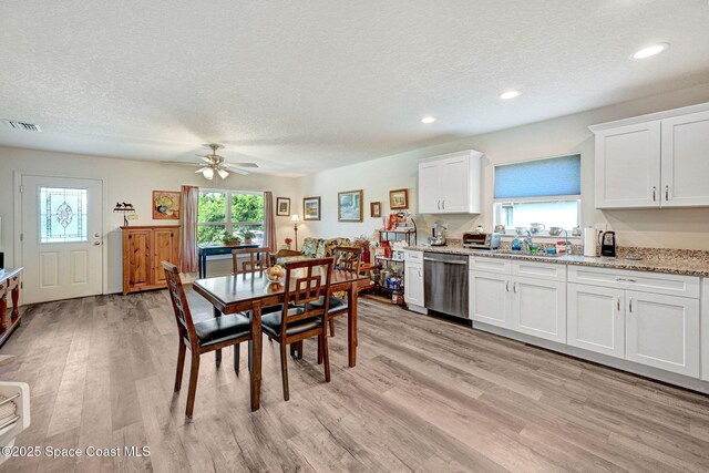 1689 Colorado St SE, Palm Bay, FL 32909 - dining area with a textured ceiling, light wood-style floors, a ceiling fan, and recessed lighting