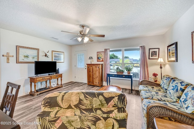 1689 Colorado St SE, Palm Bay, FL 32909 - living room with light wood-style flooring, a ceiling fan, and a textured ceiling