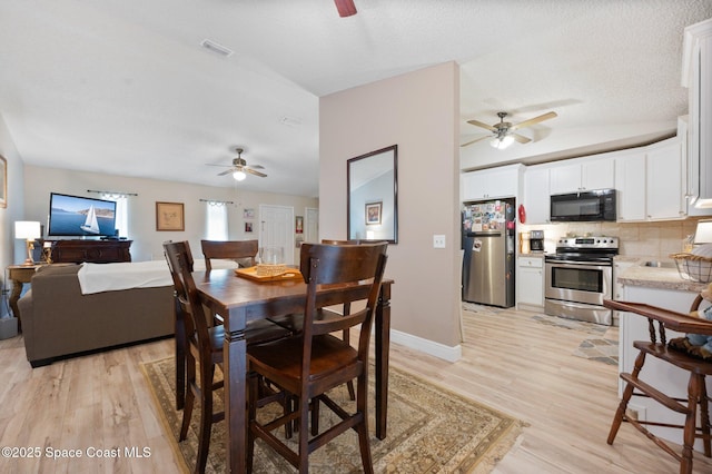 6640 Dock Ave, Cocoa, FL 32927 - dining area with a ceiling fan, light wood finished floors, and a textured ceiling