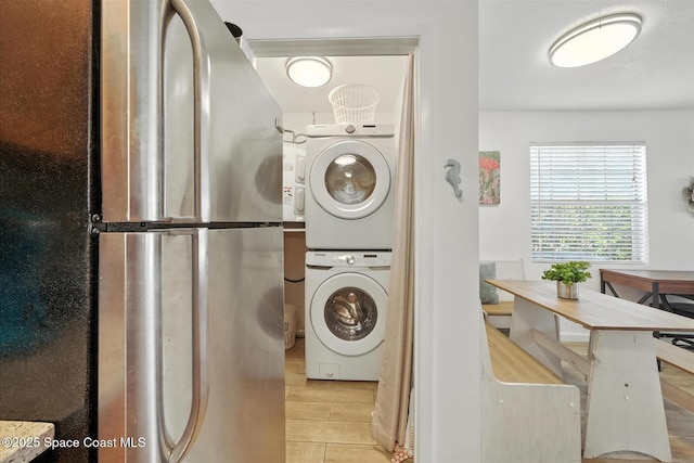 1951 Island Club Dr Unit 3-48, Melbourne, FL 32903 - washroom with stacked washer and clothes dryer and tile patterned floors