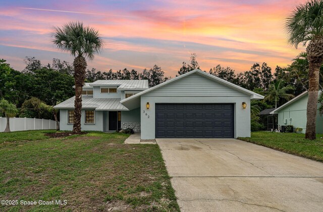 362 Nikomas Way, Melbourne Beach, FL 32951 - mid-century home featuring stucco siding, a garage, concrete driveway, and a metal roof
