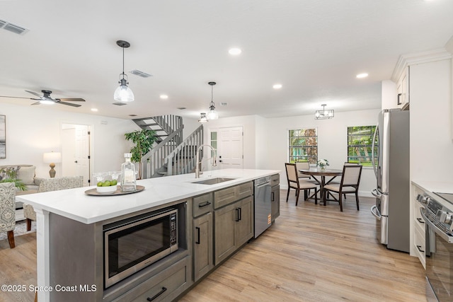 362 Nikomas Way, Melbourne Beach, FL 32951 - kitchen featuring stainless steel appliances, open floor plan, light countertops, light wood-style flooring, and recessed lighting