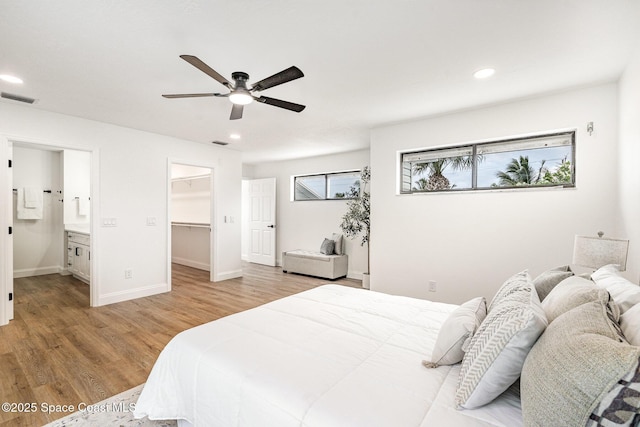 362 Nikomas Way, Melbourne Beach, FL 32951 - bedroom featuring light wood-style flooring, a walk in closet, recessed lighting, ensuite bathroom, and ceiling fan