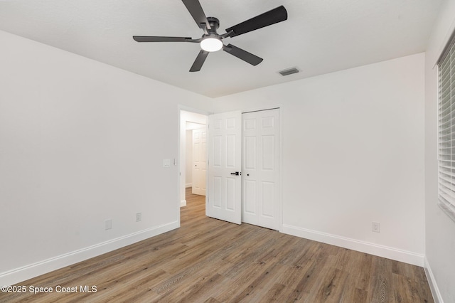 362 Nikomas Way, Melbourne Beach, FL 32951 - unfurnished bedroom featuring wood finished floors, a closet, and ceiling fan