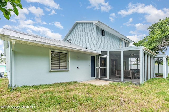 362 Nikomas Way, Melbourne Beach, FL 32951 - back of house with a sunroom, a lawn, and stucco siding