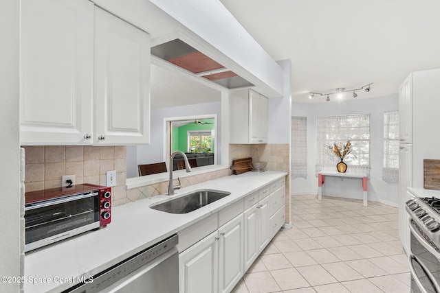 1745 Crane Creek Blvd, Melbourne, FL 32940 - kitchen with stainless steel appliances, white cabinets, decorative backsplash, light countertops, and light tile patterned floors