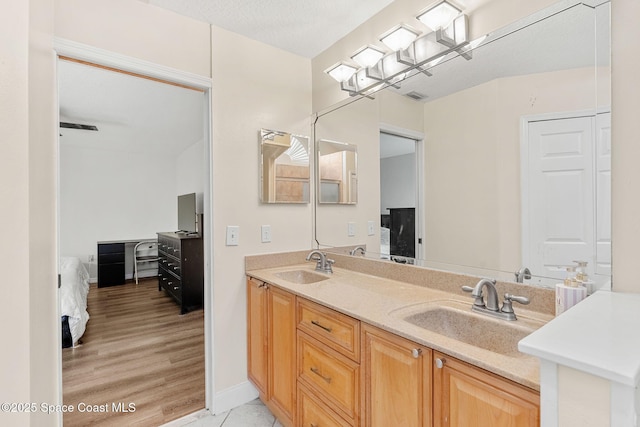 1745 Crane Creek Blvd, Melbourne, FL 32940 - ensuite bathroom featuring double vanity and wood finished floors