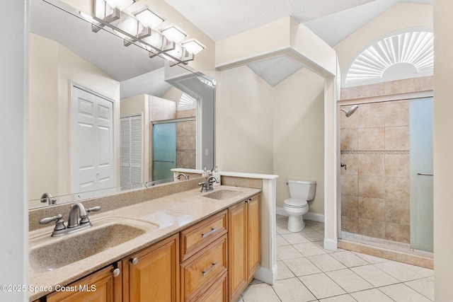 1745 Crane Creek Blvd, Melbourne, FL 32940 - bathroom featuring a stall shower, double vanity, tile patterned flooring, and a closet