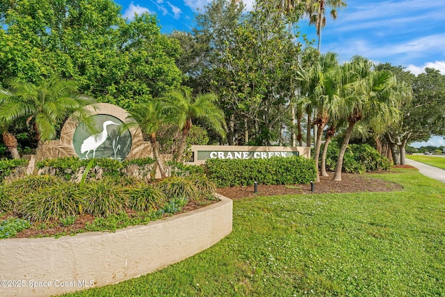 1745 Crane Creek Blvd, Melbourne, FL 32940 - community sign featuring a lawn and view of scattered trees