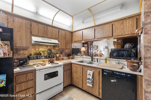 313 La Paloma Ln, Titusville, FL 32780 - kitchen featuring black appliances, under cabinet range hood, brown cabinetry, and light countertops