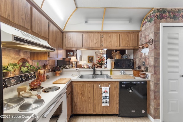 313 La Paloma Ln, Titusville, FL 32780 - kitchen with black appliances, under cabinet range hood, light countertops, and brown cabinets