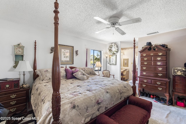 313 La Paloma Ln, Titusville, FL 32780 - bedroom with carpet floors, a textured ceiling, ceiling fan, and connected bathroom