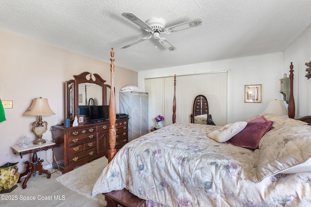 313 La Paloma Ln, Titusville, FL 32780 - carpeted bedroom with ceiling fan and a textured ceiling